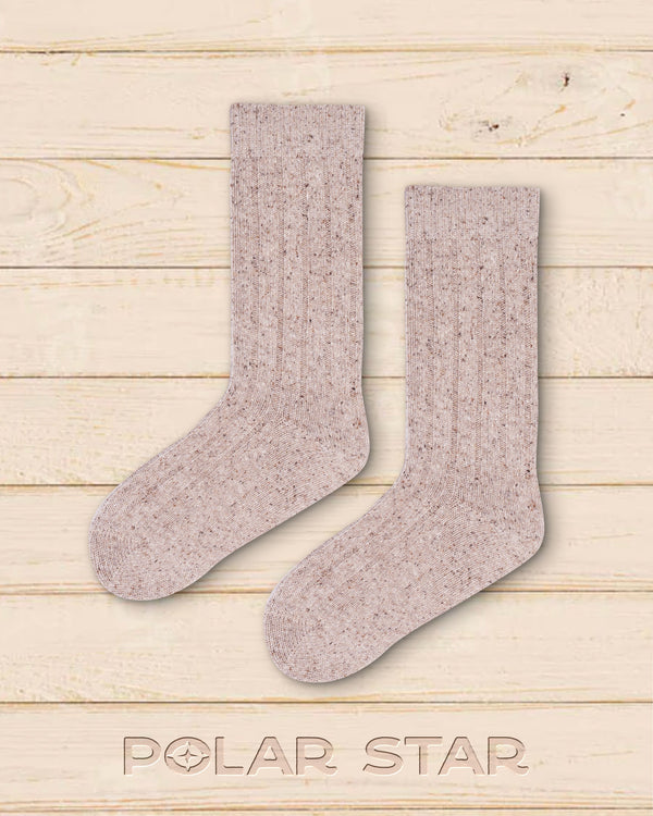 Lotte socks laid flat, plain beige knit in wool and silk on pale wood