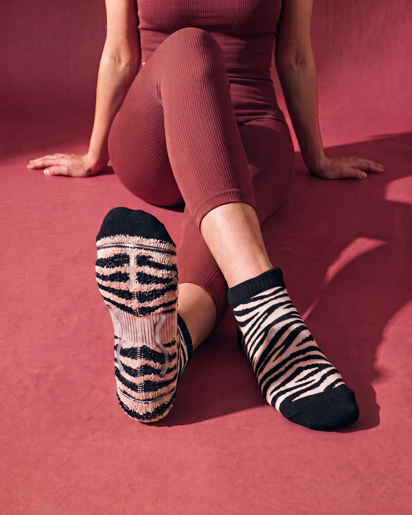 Onyx: meia de Pilates do avesso, laçadas de felpa espessas com padrão zebra sob todo o pé e duas tiras de silicone transparente no interior