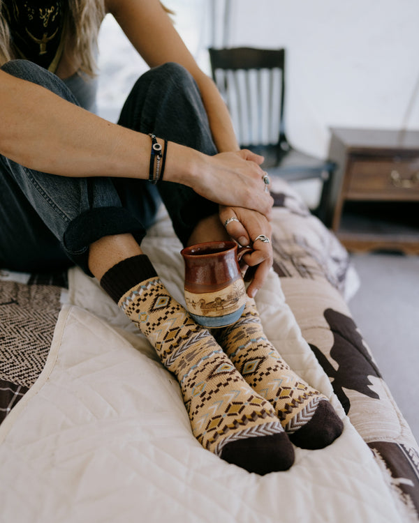Arild nordic socks worn, overhead view of feet resting on a hiking map