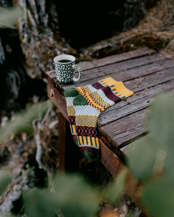 Svea nordic socks worn with hiking boots, standing on a rock in a stream