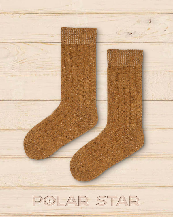 Lotto socks laid flat, plain yellow knit in wool and silk on pale wood