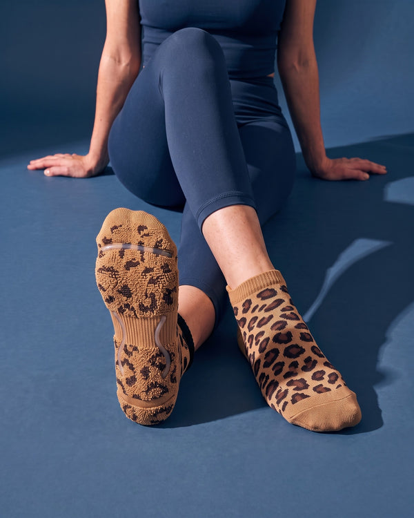 Savanna: meia de Pilates do avesso, laçadas de felpa espessas com padrão leopardo sob todo o pé e duas tiras de silicone transparente no interior