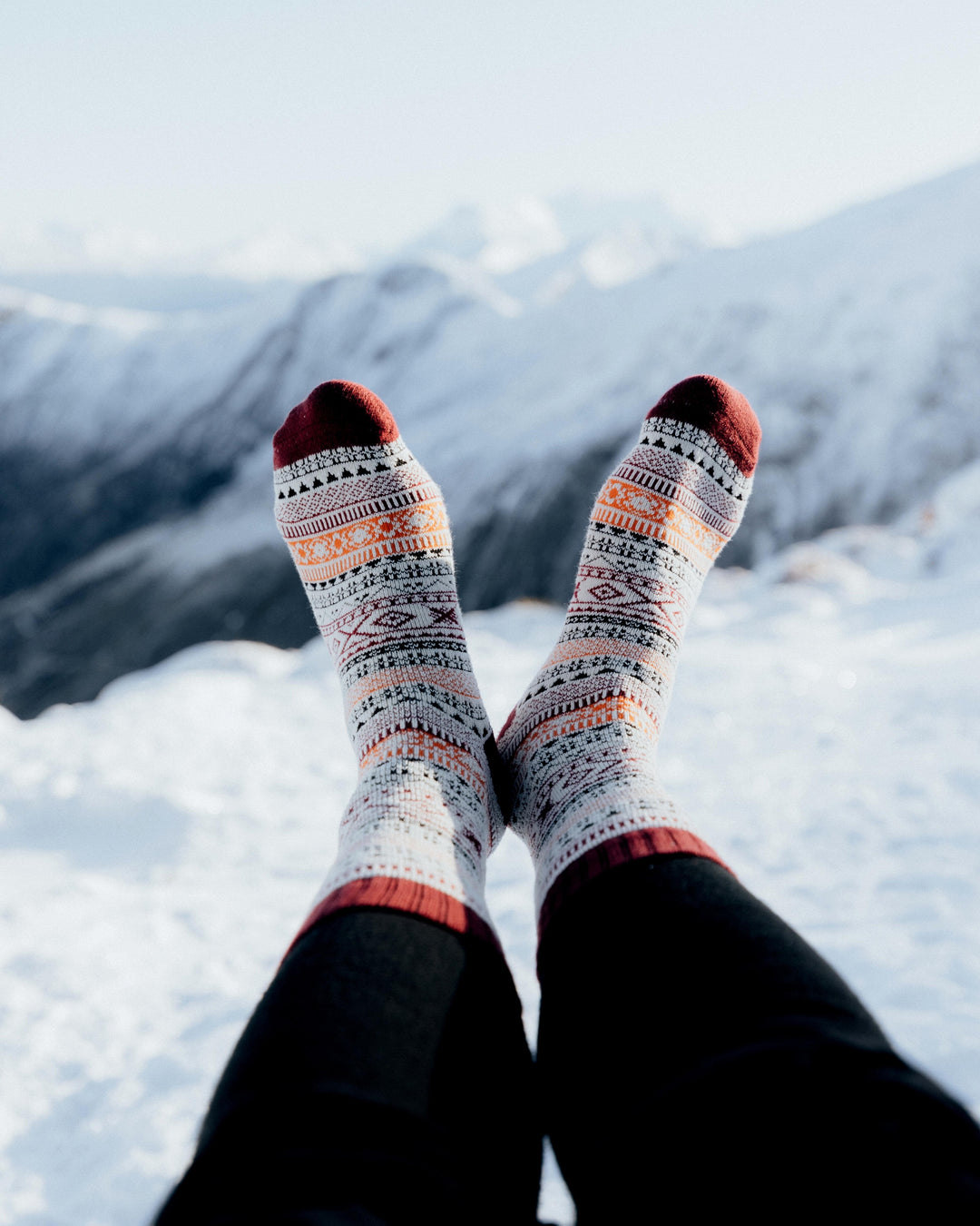Ada nordic socks worn indoors, overhead view with cups of coffee and biscuits