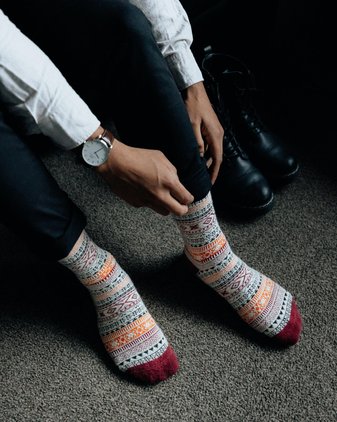 Ada nordic socks worn indoors, one bare leg and one leg in jeans and a boot