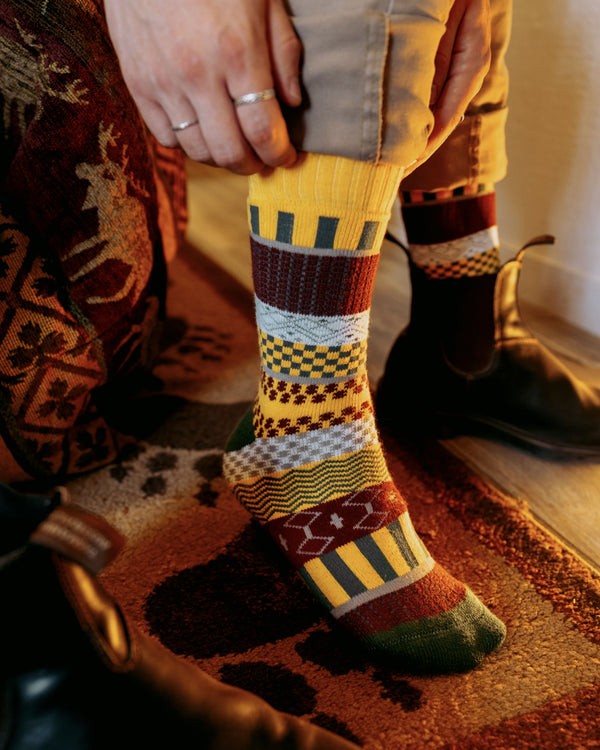 Svea nordic socks worn indoors, overhead view with cups of coffee and biscuits