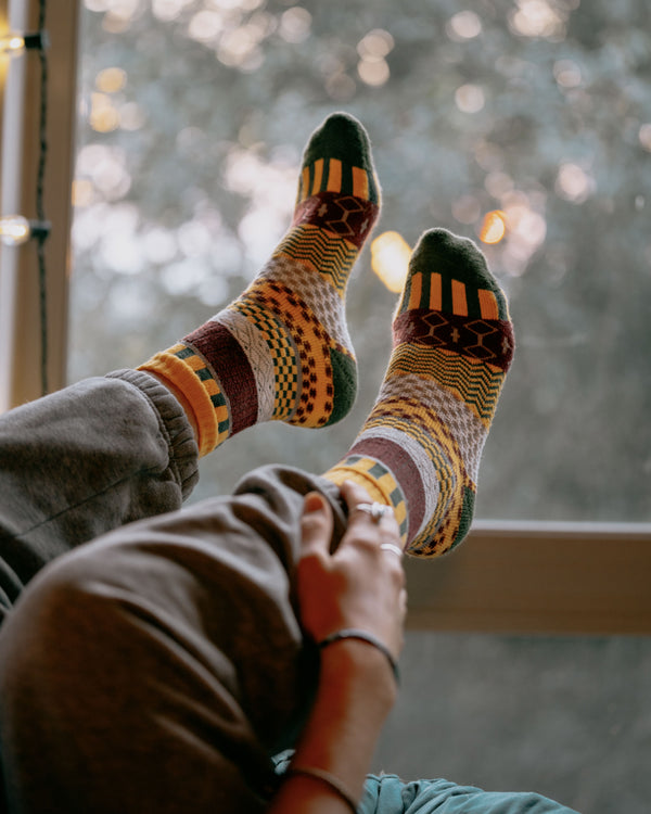 Svea nordic socks worn, overhead view of feet resting on a hiking map