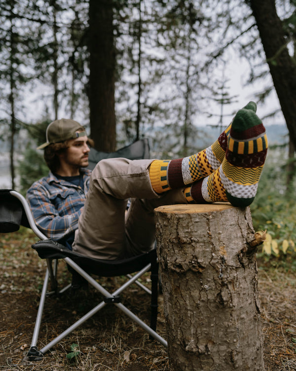Svea nordic socks worn indoors, one bare leg and one leg in jeans and a boot